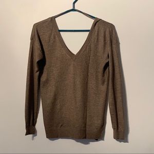 Brown V-neck sweater.